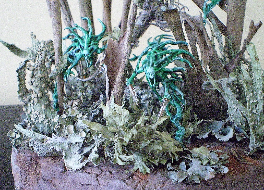 Spirit Hosts
These are Spirit Hosts from the Warhammer: Age of Sigmar series. The  
diorama is composed of lichen from pecan trees, bark from a crepe  
myrtle and the odd bit of ball moss. All from the yard. The base is  
florist foam covered in pre- colored tile grout.


