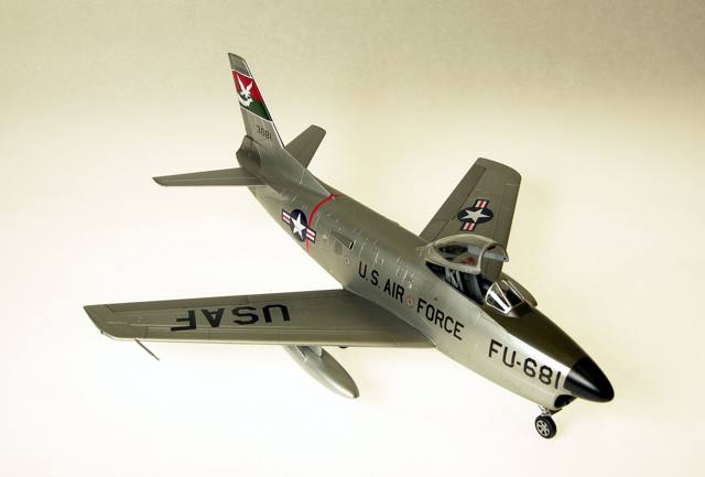 F-86L
1/48 Revell F86D with a Hasegawa F86F-40 wing creating the F86L, also identified by the (added detail) SAGE antenna at the left wing root. Eduard's F86 Sabredog photoetch set was used externally and internally, especially to replace the prototype instrument panel and its shroud; 330th FIS USAF; Alclad, Tamiya, Gunze, Model Master and Polly S paints; Cutting Edge and kit decals. The white tail art was reproduced as a decal by Milton Bell.
