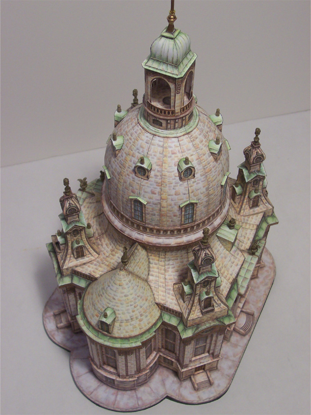 Frauenkirche Dresden (1/300 Schreiber Bogen)
This is a 1/300 paper model by Schreiber Bogen of the famous Frauenkirche Dresden (Church of Our Lady).  It was built by an engineer/architect/local genius named George Bahr in 1733 out of pure stone.  Even the gigantic bell is stone because copper covered wood was too expensive(!).  It caught fire in the 1945 Dresden firebombing.  Though it wasn’t hit directly, the firestorm consumed the interior furnishings sufficiently weakening the structural piers holding the church bell aloft until it finally collapsed two days later.  During the 45 year East German era the site stayed just as it had the day the last stone rolled to a rest.  After reunification, the church was completely rebuilt using the original plans and modern adaptations.  If you look at the modern façade it is pockmarked with original blackened stones from the original structure found at the site.  It’s an uniquely amazing building with an equally amazing history.
http://www.frauenkirche-dresden.de/zerstoerung+M5d637b1e38d.html
