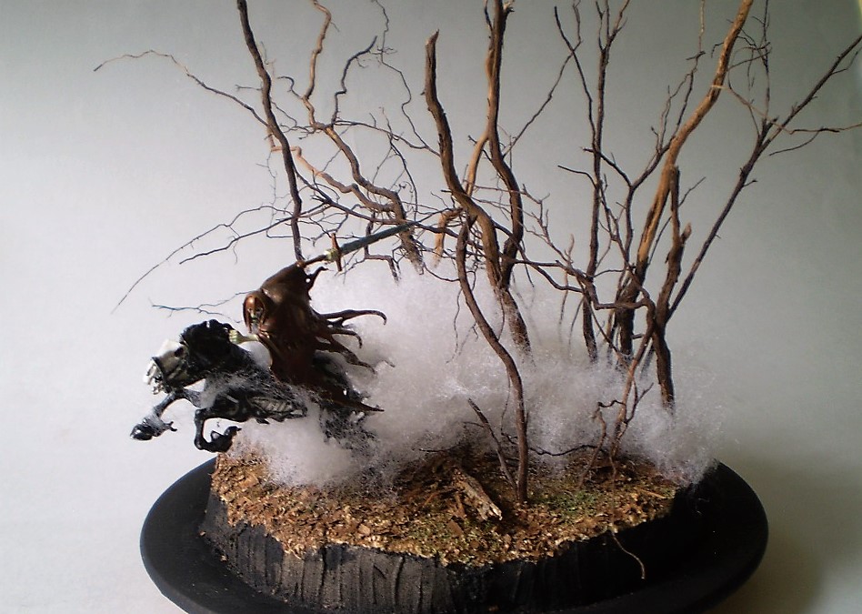 Dreadblade Harrow (Warhammer/Age of Sigmar 1/60)
This is a Warhammer/Age of Sigmar 1/60th scale Dreadblade Harrow. The   
fog is teased out batten from the fabric store with the 'trees' are   
actually roots from a dead Rosemary bush. (A victim of the great   
freeze of '21.)
