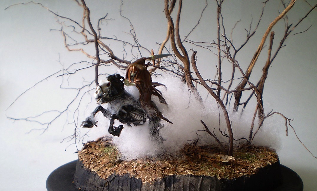 Dreadblade Harrow (Warhammer/Age of Sigmar 1/60)
This is a Warhammer/Age of Sigmar 1/60th scale Dreadblade Harrow. The   
fog is teased out batten from the fabric store with the 'trees' are   
actually roots from a dead Rosemary bush. (A victim of the great   
freeze of '21.)
