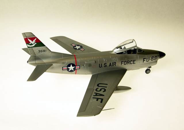 F-86L
1/48 Revell F86D with a Hasegawa F86F-40 wing creating the F86L, also identified by the (added detail) SAGE antenna at the left wing root. Eduard's F86 Sabredog photoetch set was used externally and internally, especially to replace the prototype instrument panel and its shroud; 330th FIS USAF; Alclad, Tamiya, Gunze, Model Master and Polly S paints; Cutting Edge and kit decals. The white tail art was reproduced as a decal by Milton Bell.
