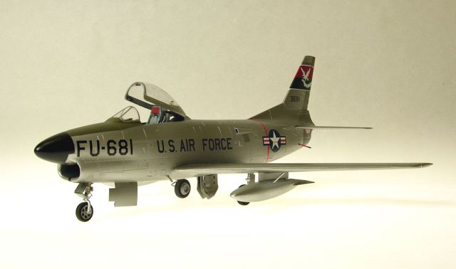 F-86L
1/48 Revell F86D with a Hasegawa F86F-40 wing creating the F86L, also identified by the (added detail) SAGE antenna at the left wing root. Eduard's F86 Sabredog photoetch set was used externally and internally, especially to replace the prototype instrument panel and its shroud; 330th FIS USAF; Alclad, Tamiya, Gunze, Model Master and Polly S paints; Cutting Edge and kit decals. The white tail art was reproduced as a decal by Milton Bell.
